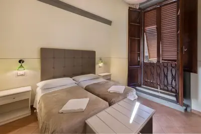 Letto o letti in una camera di B&B Soggiorno Battistero