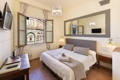 Letto o letti in una camera di B&B Soggiorno Battistero