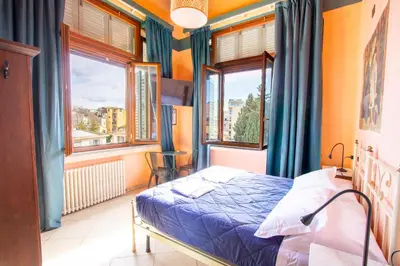 Letto o letti in una camera di Hotel Merlini