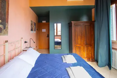 Letto o letti in una camera di Hotel Merlini