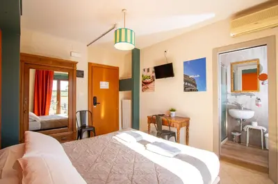 Letto o letti in una camera di Hotel Merlini