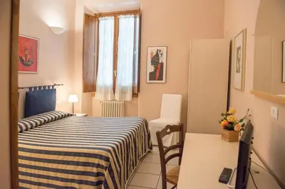 Letto o letti in una camera di Affittacamere Benedetta