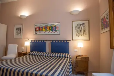 Letto o letti in una camera di Affittacamere Benedetta