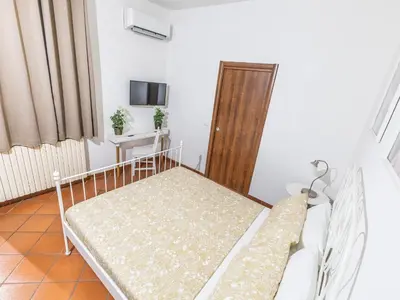 Letto o letti in una camera di San Lorenzo affittacamere