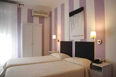 Letto o letti in una camera di Hotel Alex