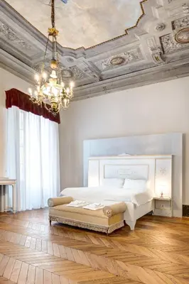 Letto o letti in una camera di Palazzo D'Oltrarno - Residenza D'Epoca