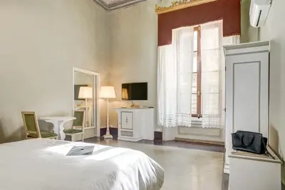 Letto o letti in una camera di Palazzo D'Oltrarno - Residenza D'Epoca