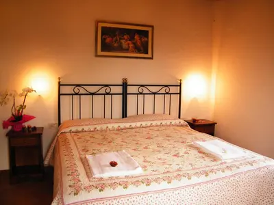 Letto o letti in una camera di B&B La Fonte del Machiavelli