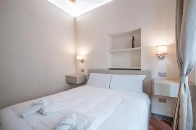 Letto o letti in una camera di GuestHost - Ponte Vecchio Central Flats