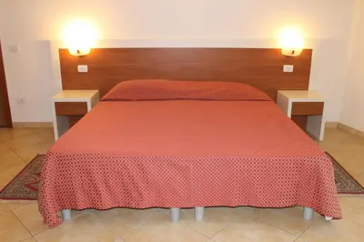 Letto o letti in una camera di B&B Soggiorno Ponte Rosso
