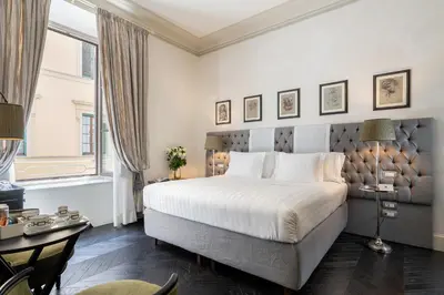 Letto o letti in una camera di Corte Calzaiuoli Elegant Suites