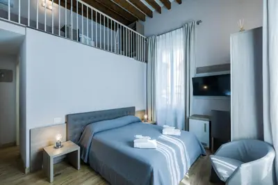 Letto o letti in una camera di VRooms All'Angolo Del Duomo