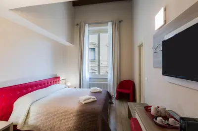 Letto o letti in una camera di VRooms All'Angolo Del Duomo
