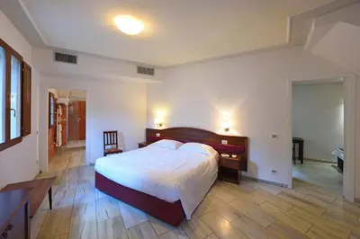 Letto o letti in una camera di Relais La Corte di Cloris