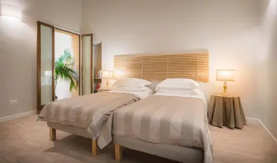 Letto o letti in una camera di Hotel Torre Guelfa Palazzo Acciaiuoli