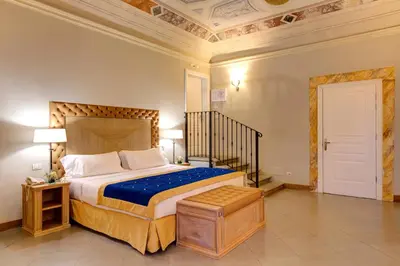 Letto o letti in una camera di Villa Tolomei Hotel & Resort
