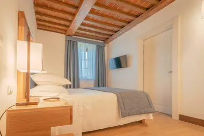 Letto o letti in una camera di Villa Tolomei Hotel & Resort