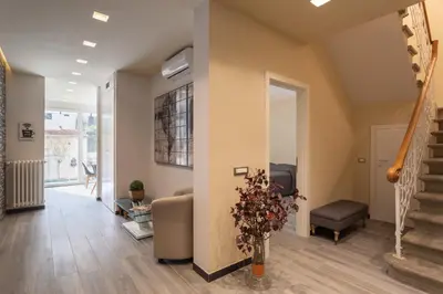 Area soggiorno di GuestHost - Le stanze di Carla! Bagno privato, cucina in comune