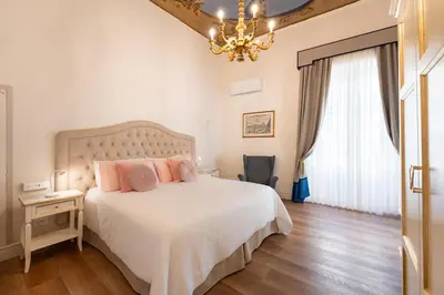 Letto o letti in una camera di Palazzo D'Ambra Residenza d'Epoca