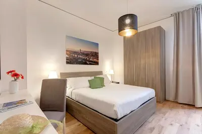 Letto o letti in una camera di David & Buonarroti Apartments by Mamo Florence
