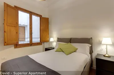 Letto o letti in una camera di David & Buonarroti Apartments by Mamo Florence