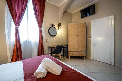 Letto o letti in una camera di HOTEL VENETO Centro Storico di Firenze