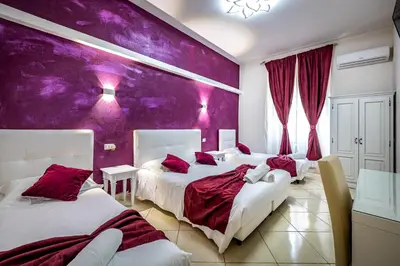 Letto o letti in una camera di HOTEL VENETO Centro Storico di Firenze