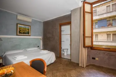 Letto o letti in una camera di Hotel Angelica Firenze