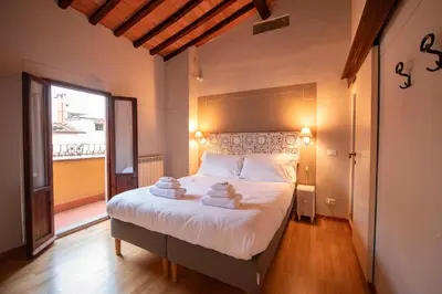Letto o letti in una camera di Duomo Suite con balcone