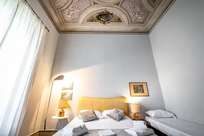 Letto o letti in una camera di Roommo D'Azeglio