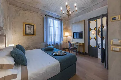 Letto o letti in una camera di Soggiorni D'Arte Apartments by Mamo Florence