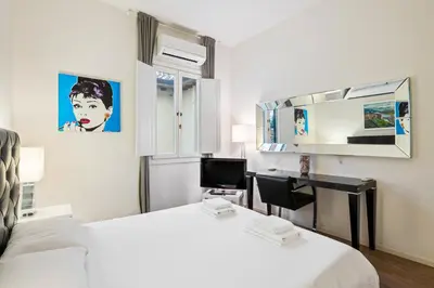 Letto o letti in una camera di GuestHost - Palazzo Pitti & Boboli Comfortable Apartment