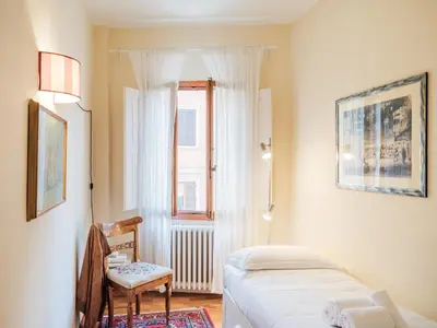 Letto o letti in una camera di Casa Anna - Charming central apartment