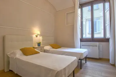 Letto o letti in una camera di Casa Michelangelo & Giotto - Tintori apt