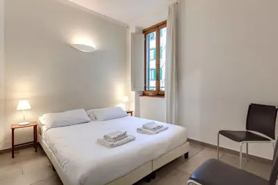 Letto o letti in una camera di Santo Stefano Apartment by Mamo Florence
