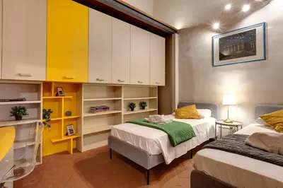 Letto o letti in una camera di Magazzini Apartment by Mamo Florence