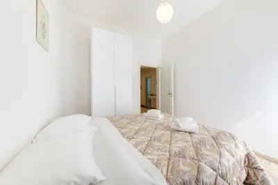 Letto o letti in una camera di GuestHost - Il Salotto Blu - Appartamento con Parcheggio