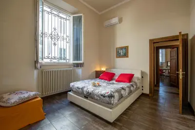 Letto o letti in una camera di Indipendenza Apartment by Mamo Florence