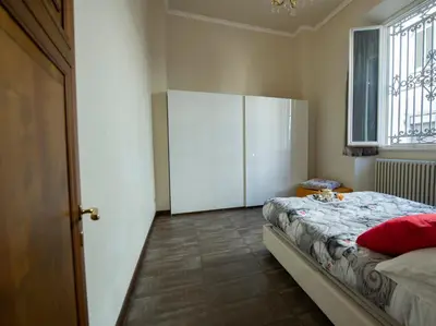 Letto o letti in una camera di Indipendenza Apartment by Mamo Florence