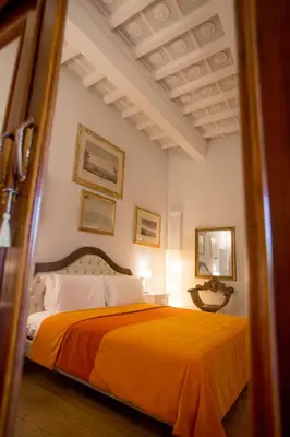 Letto o letti in una camera di Borgo Pinti Suites Le Stanze dei Nobili