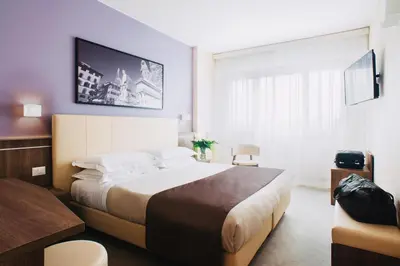 Letto o letti in una camera di Hotel Raffaello