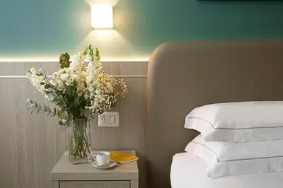 Letto o letti in una camera di Hotel Raffaello