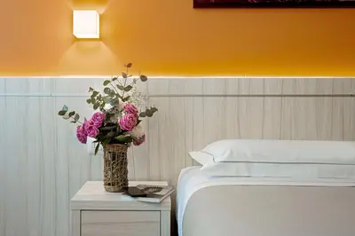 Letto o letti in una camera di Hotel Raffaello