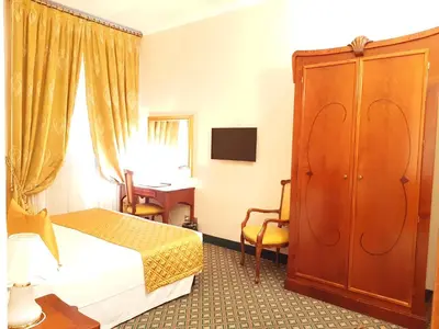 Letto o letti in una camera di Hotel Berchielli