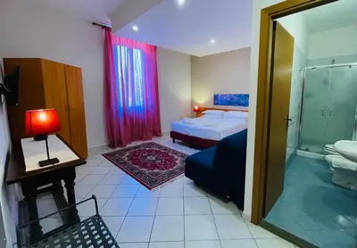 Letto o letti in una camera di Hotel Leopolda