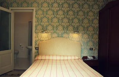 Letto o letti in una camera di Hotel Beatrice