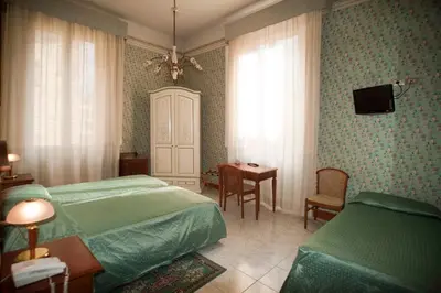 Letto o letti in una camera di Hotel Beatrice