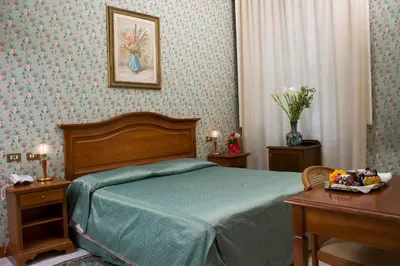 Letto o letti in una camera di Hotel Beatrice
