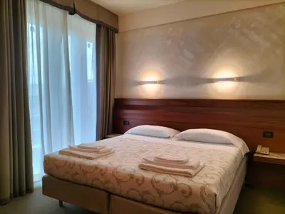 Letto o letti in una camera di Hotel Arcadia
