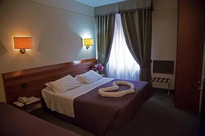 Letto o letti in una camera di Hotel Arcadia